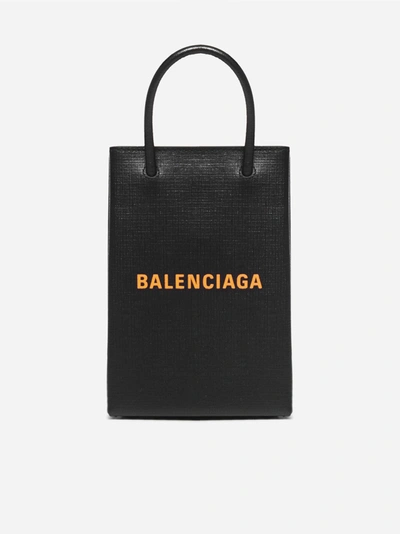 Shop Balenciaga Logo Leather Shopping Phone Holder In Black - Orange
