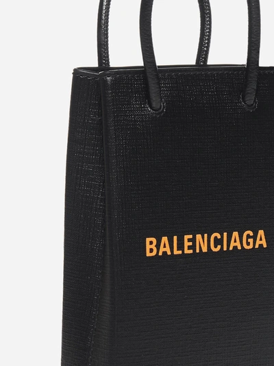 Shop Balenciaga Logo Leather Shopping Phone Holder In Black - Orange