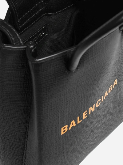 Shop Balenciaga Logo Leather Shopping Phone Holder In Black - Orange