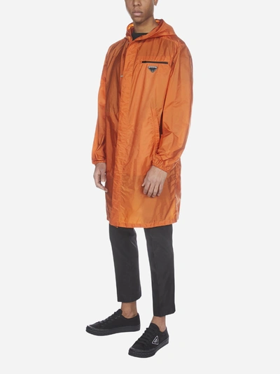 Shop Prada Logo-plaque Nylon Piuma Hooded Raincoat In Orange