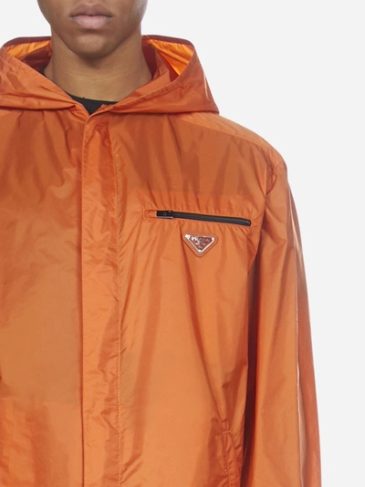 Shop Prada Logo-plaque Nylon Piuma Hooded Raincoat In Orange