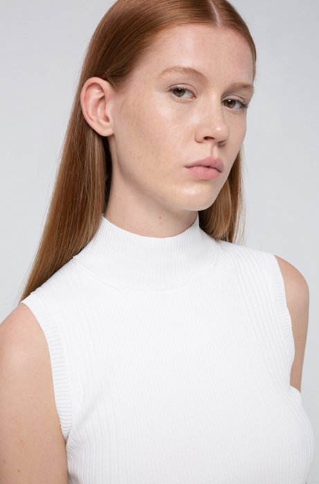 white sleeveless mock neck top