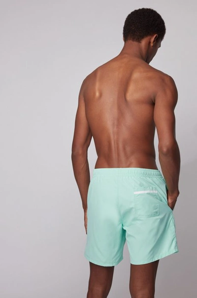 Shop Hugo Boss - Medium Length Swim Shorts With Heat Sealed Logo Print - Light Green