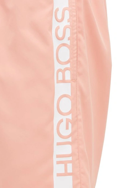 Shop Hugo Boss - Medium Length Swim Shorts With Heat Sealed Logo Print - Light Red