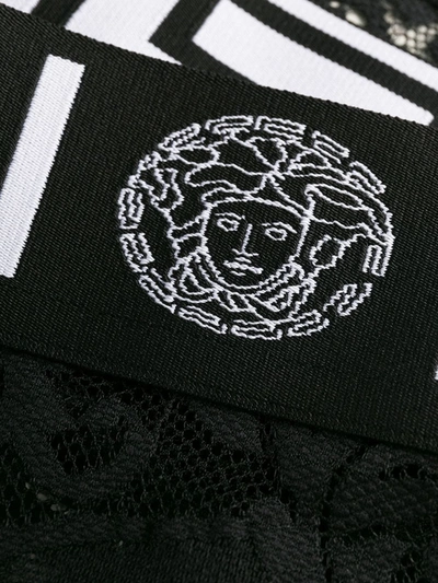 Shop Versace Lace Logo-embellished Briefs In Black