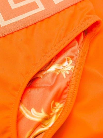 Shop Versace Greca Border Swim Briefs In Orange