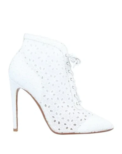 Shop Alaïa Ankle Boots In White