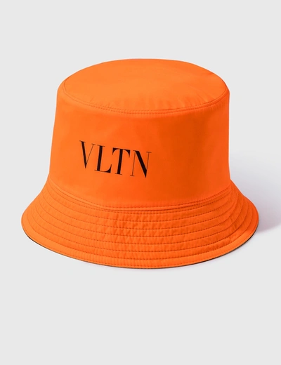 Shop Valentino Garavani Vltn Reversible Bucket Hat In Black/orange