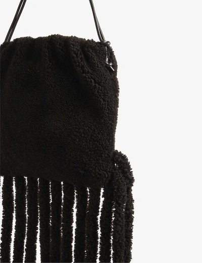 Shop Bottega Veneta Fringed Shearling Bag In Fondentgold