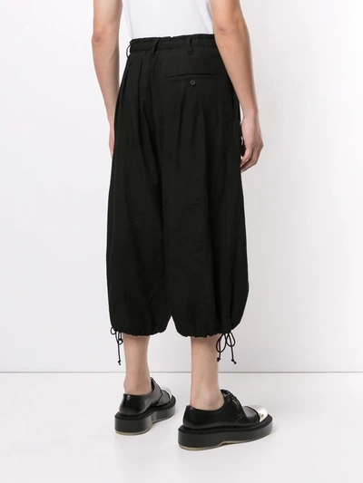Shop Yohji Yamamoto Ripped-effect Cropped Trousers In Black