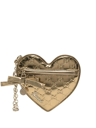 Shop Gucci Monogram Heart Clutch In Gold