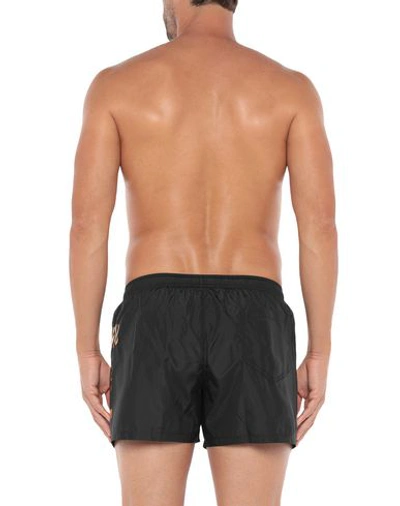 Shop Moschino Swim Trunks In Black