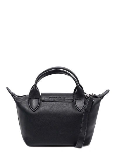 Shop Longchamp Xs Le Pliage Cuir Top Handle Bag In Black