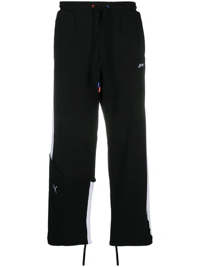 Shop Puma Contrast-stripe Track Pants In Black