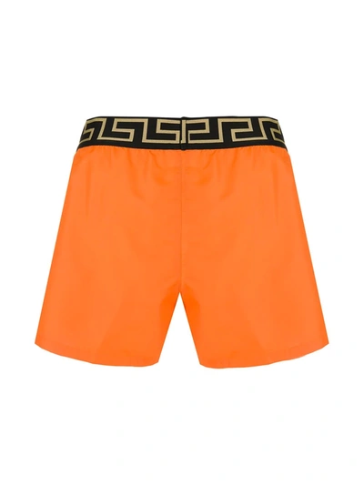 Shop Versace Greca Waistband Boxer Shorts In Orange