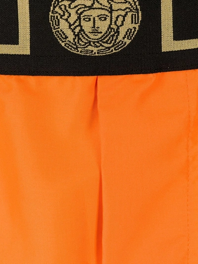 Shop Versace Greca Waistband Boxer Shorts In Orange