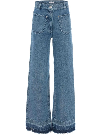 Shop Jw Anderson Bootleg Raw Hem Jeans In Blue