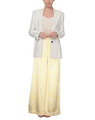 Shop Ganni Pants In Yellow