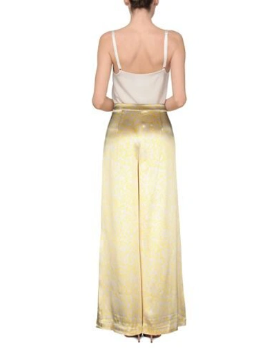 Shop Ganni Pants In Yellow