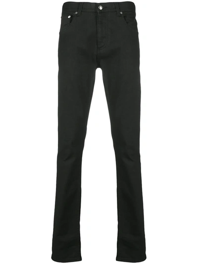 Shop Alexander Mcqueen Logo-studded Slim-fit Jeans In Black