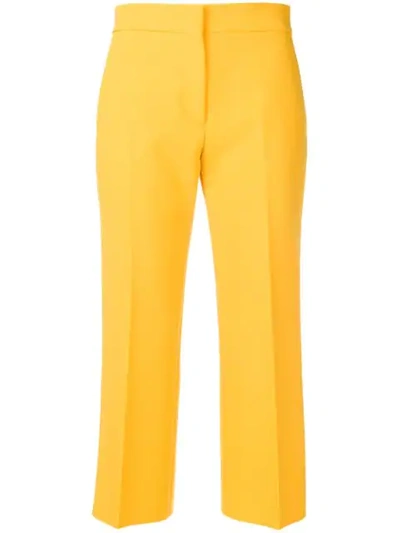 Msgm Cropped Pleated Trousers In Yellow