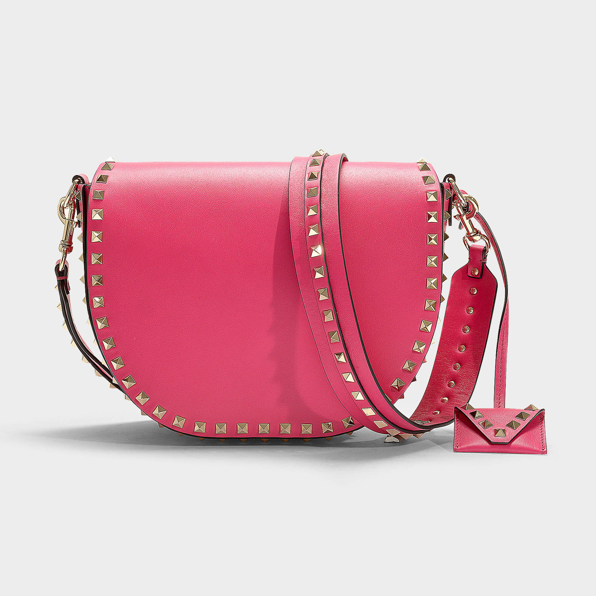 Valentino Garavani | Rockstud Saddle Bag In Black Calfskin In Pink ...