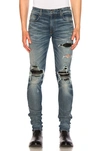 Amiri Mx1 Distressed Leather-panel Slim-leg Jeans In Black