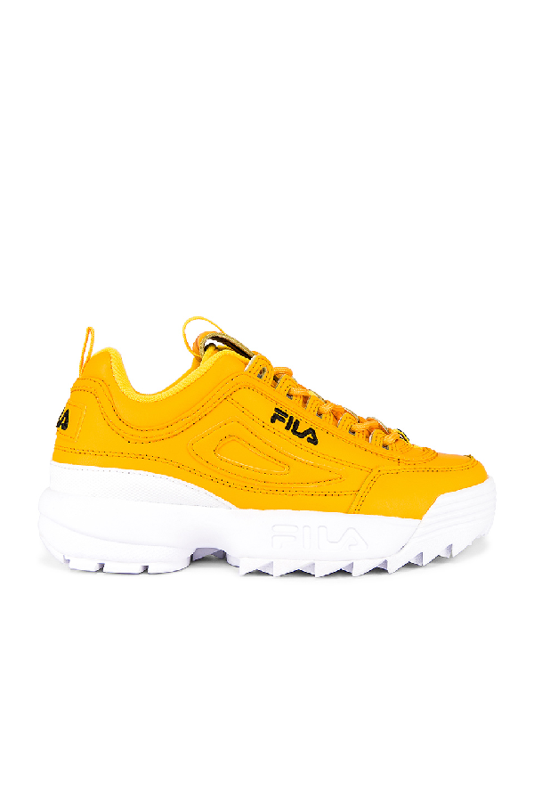 white and gold fila disruptor