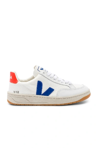 Veja V 12 Sneaker In White. In White  Indigo & Orange Fluo