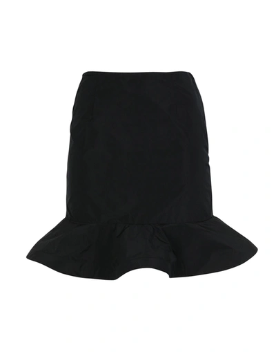 Au Jour Le Jour Knee Length Skirts In Black