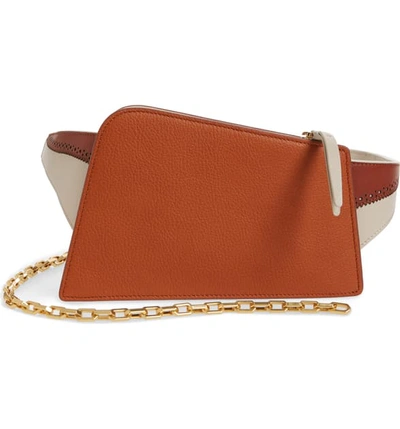 The Volon Dia Asymmetrical Convertible Leather Belt Bag - Orange In Pumpkin