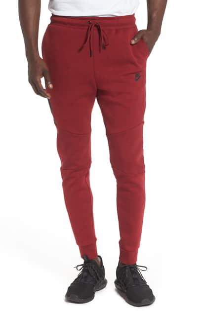 red nike tech joggers