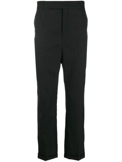 Saint Laurent Pinstriped Tapered Trousers In Black