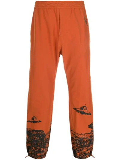 Undercover Valentino Tapered Printed And Embroidered Nylon-blend Sweatpants In Orange