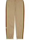 Gucci Slim-fit Webbing-trimmed Cotton-drill Trousers In Brown