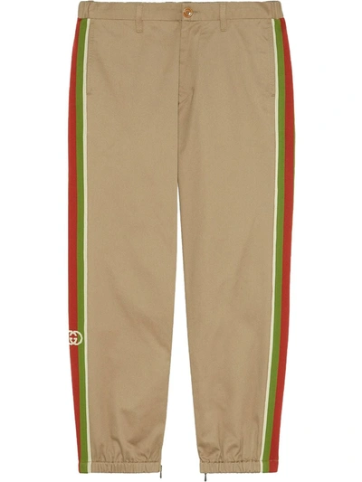 Gucci Slim-fit Webbing-trimmed Cotton-drill Trousers In Neutrals