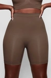 Skims Sculpting Mid Thigh Shorts In Oxide