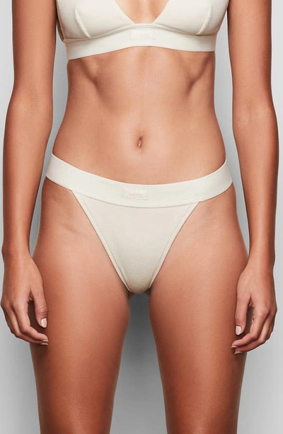 Skims Cotton Collection Ribbed Cotton-blend Jersey Thong In Bone