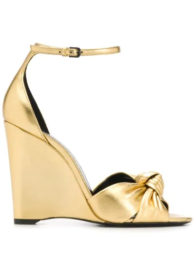 Saint Laurent Bianca Knotted Metallic Leather Wedge Sandals In Gold