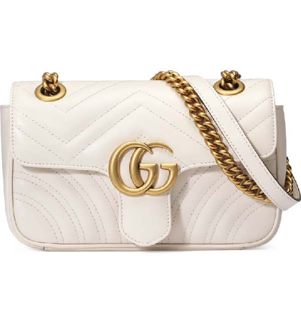 white gucci purse with heart on back