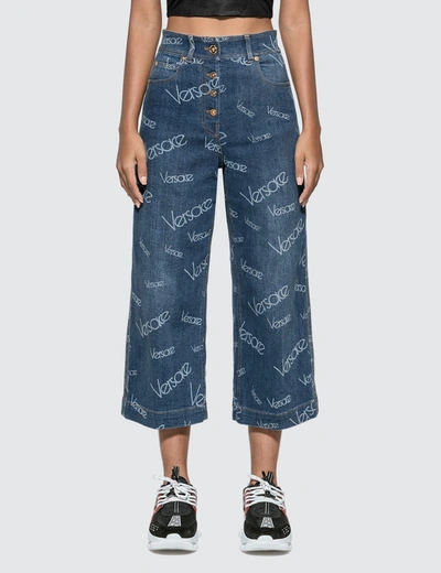 Versace Logomania Print Wide Leg Cropped Jeans In Blue