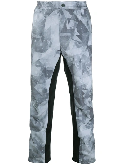 White Mountaineering X Colman Age Geometric Print Trousers In Grey