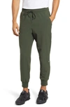Alo Yoga Co-op Water Repellent Pocket 7/8 Joggers In Hunter