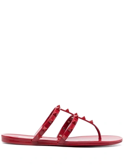 Valentino Garavani Jelly Rockstud Flat Thong Sandals In Rosso Valentino