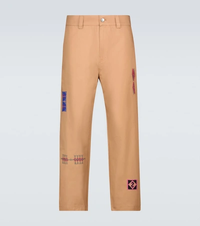 Adish Embroidered-motif Chino Trousers In Beige