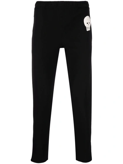 Alexander Mcqueen Jogging Pants With Embroidered Skull In Black