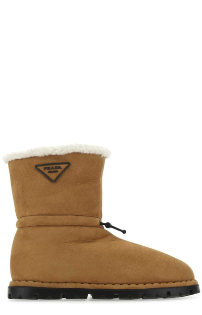 Prada Logo Patched Shearling Boots In Camel