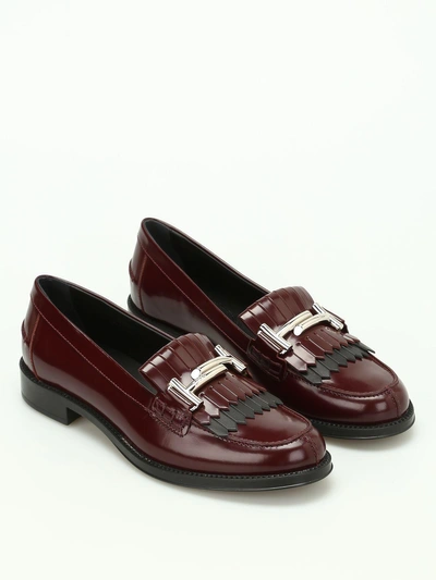 Tod's Double T Fringed Leather Loafers In Must+black