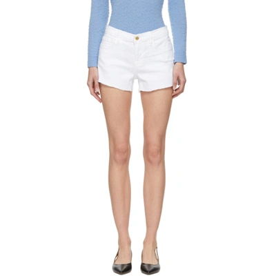 Frame Frayed Denim Cut Off Shorts In Blanc