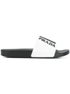 Prada Logo Embossed Flat Slides In White